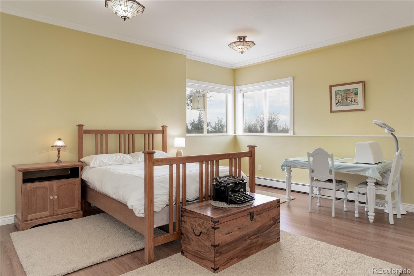 24943 Ben Kelly Road Elbert, CO 80106 - Photo 28 of 39 a bedroom with a bed a table and chair