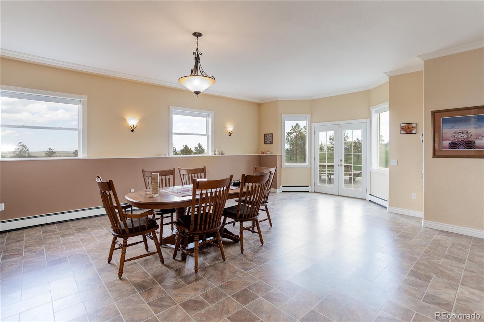 24943 Ben Kelly Road Elbert, CO 80106 - Photo 31 of 39 a view of a dining room with furniture window and wooden floor