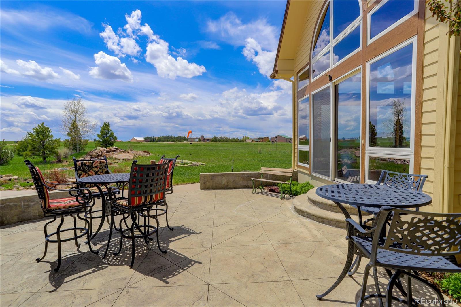 24943 Ben Kelly Road Elbert, CO 80106 - Photo 34 of 39 a view of a patio with a table and chairs