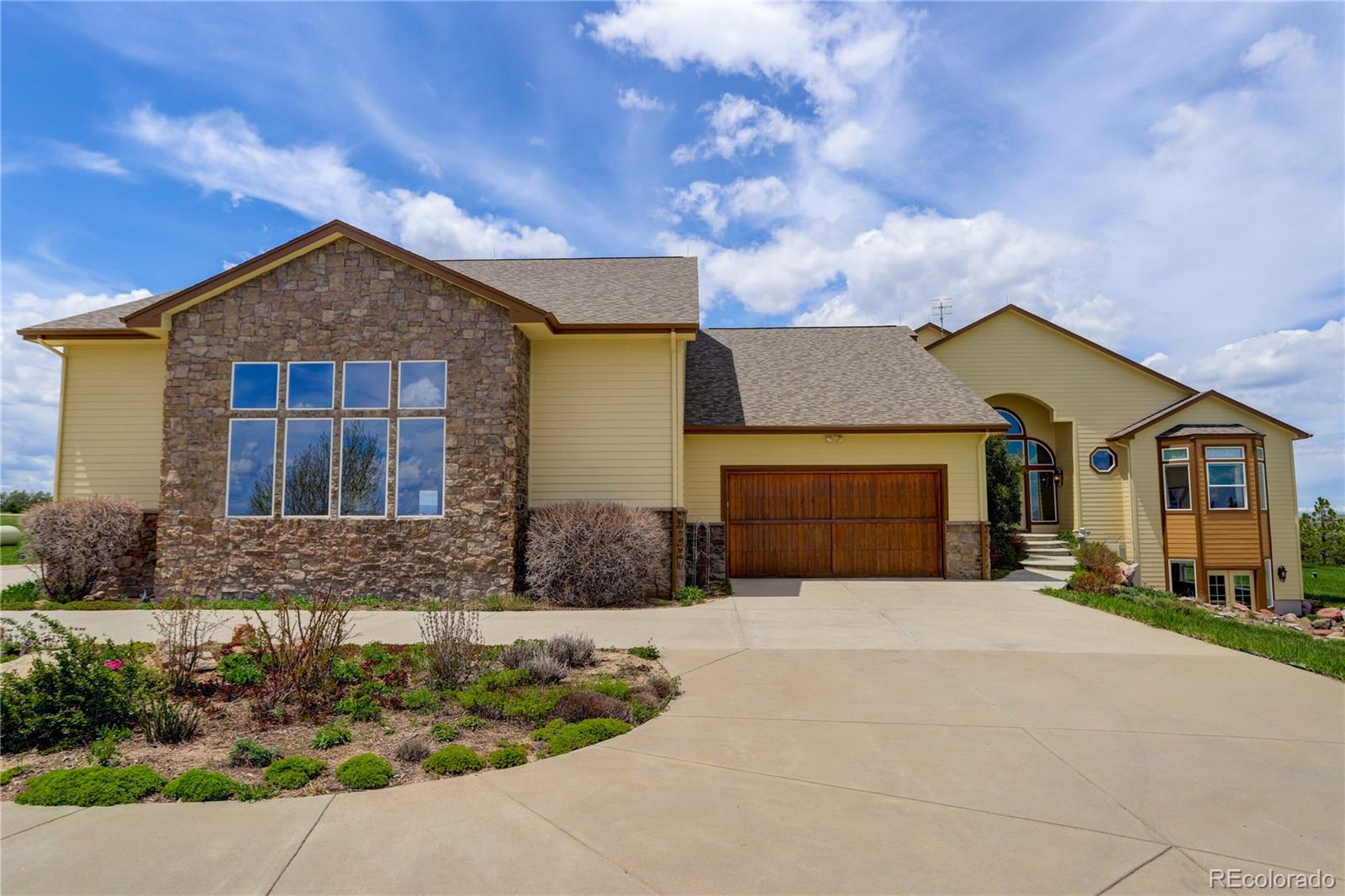 24943 Ben Kelly Road Elbert, CO 80106 - Photo 5 of 39 a front view of a house with yard and parking