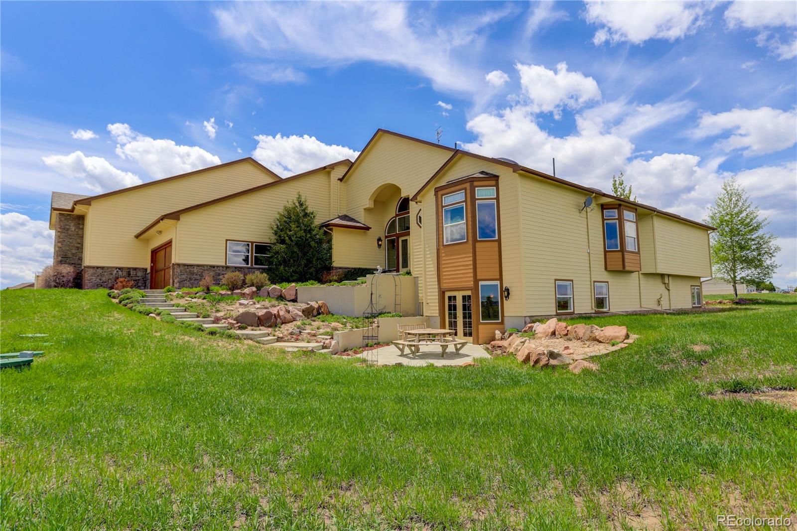 24943 Ben Kelly Road Elbert, CO 80106 - Photo 6 of 39 a front view of house with garden