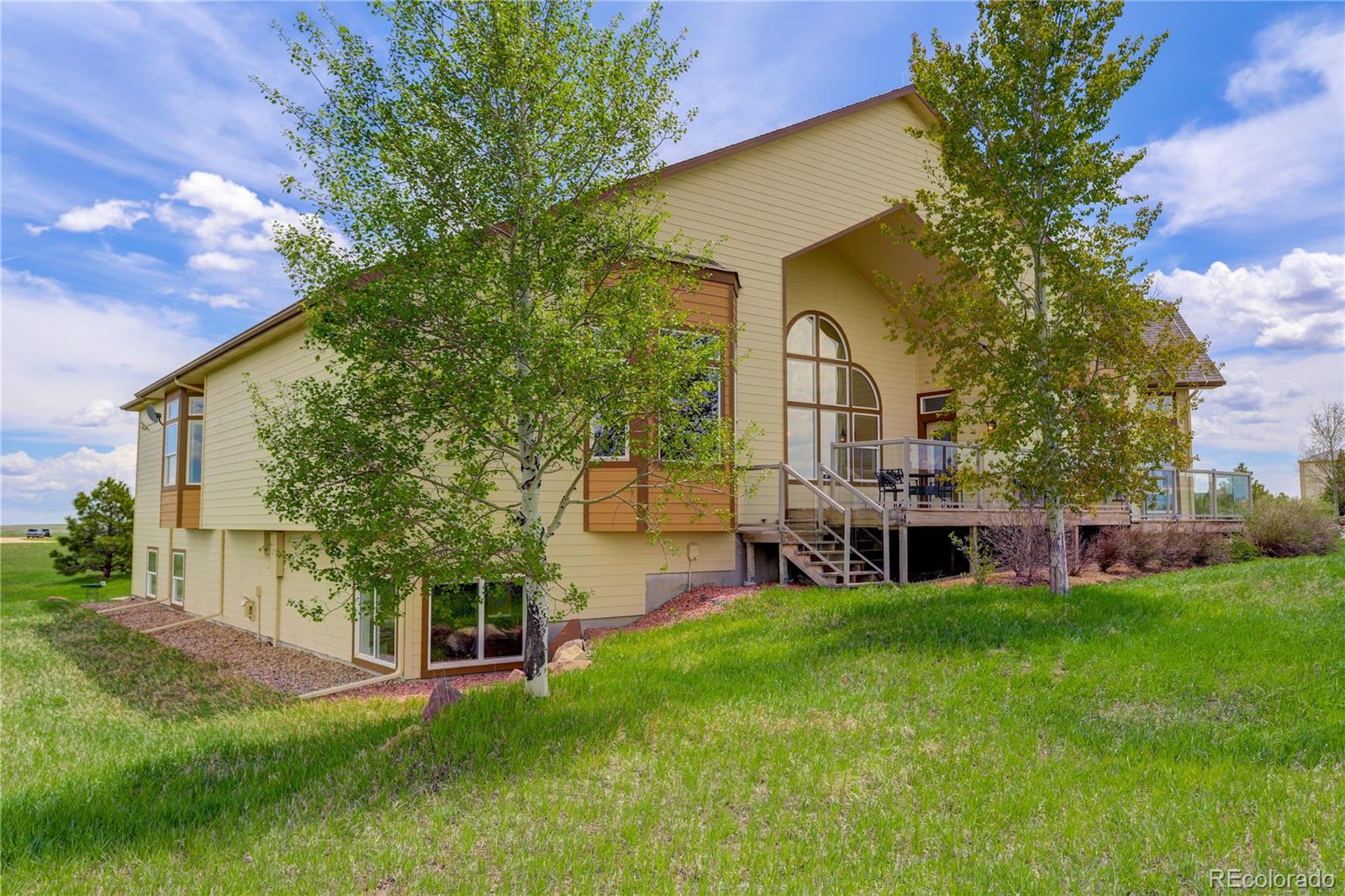 24943 Ben Kelly Road Elbert, CO 80106 - Photo 7 of 39 a view of a house with a yard porch and sitting area
