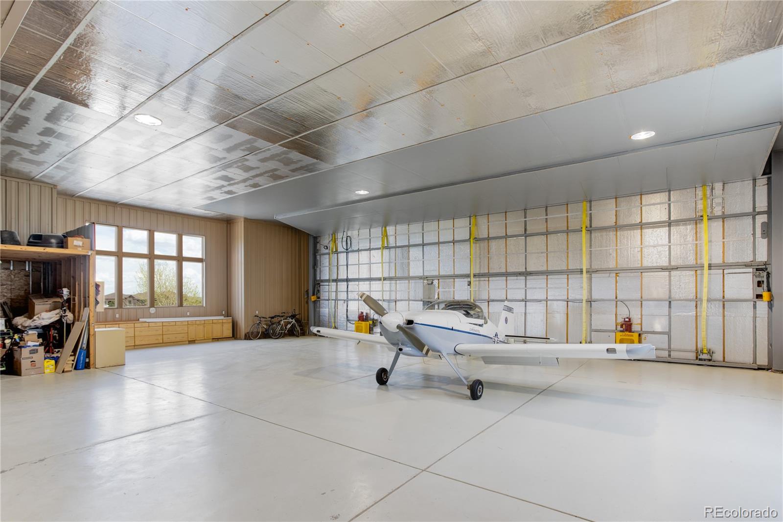 24943 Ben Kelly Road Elbert, CO 80106 - Photo 9 of 39 a living room with furniture and a chandelier