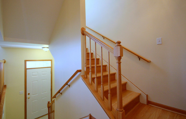 1283 Georgetown Way Vernon Hills, IL 60061 - Photo 2 of 25 a view of staircase with wooden floor and white walls