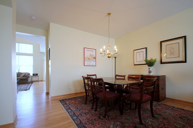 1283 Georgetown Way Vernon Hills, IL 60061 - Photo 6 of 25 a view of a dining room with furniture wooden floor and chandelier