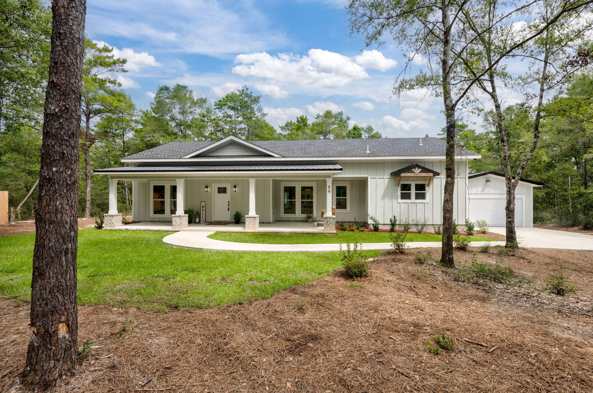 a front view of a house with a yard and porch