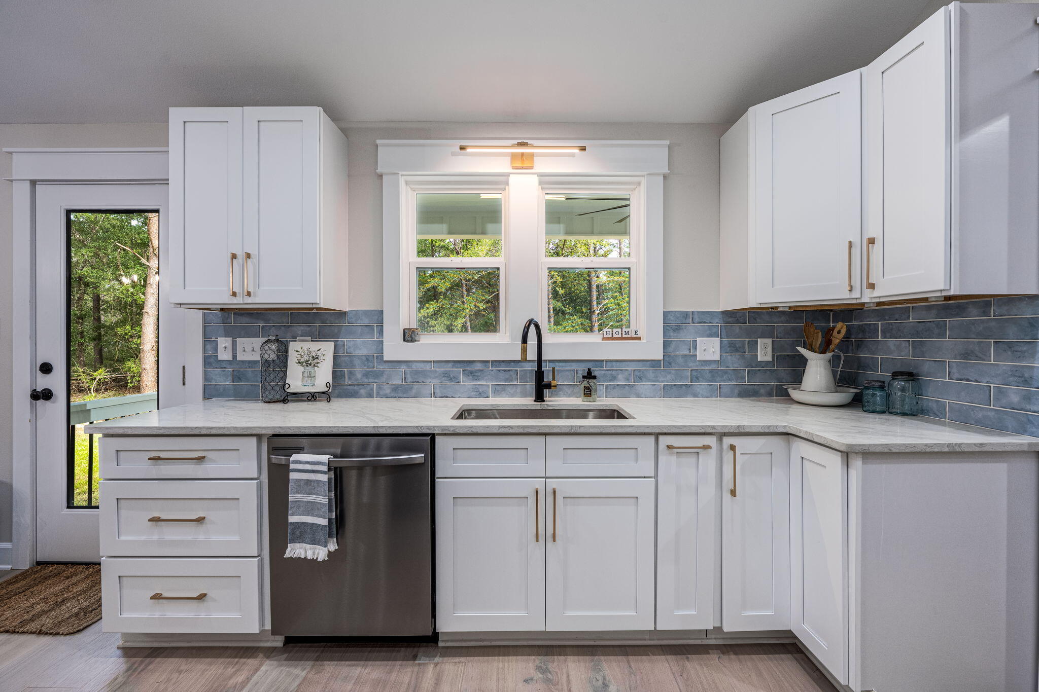 89 Spring Hill Road DeFuniak Springs, FL 32433 - Photo 21 of 73 a kitchen with white cabinets and a window