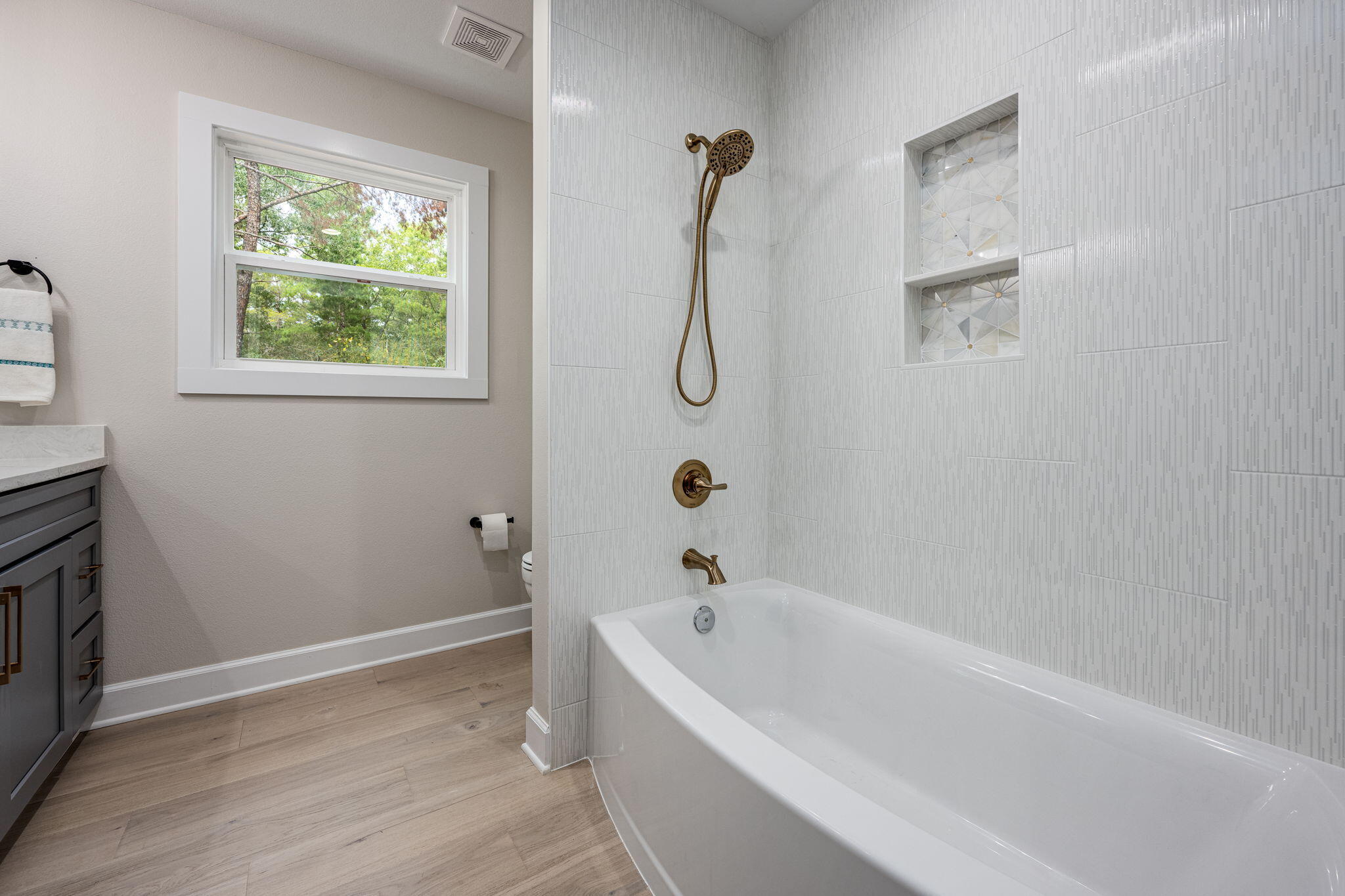 89 Spring Hill Road DeFuniak Springs, FL 32433 - Photo 28 of 73 a white bath tub sitting next to a window