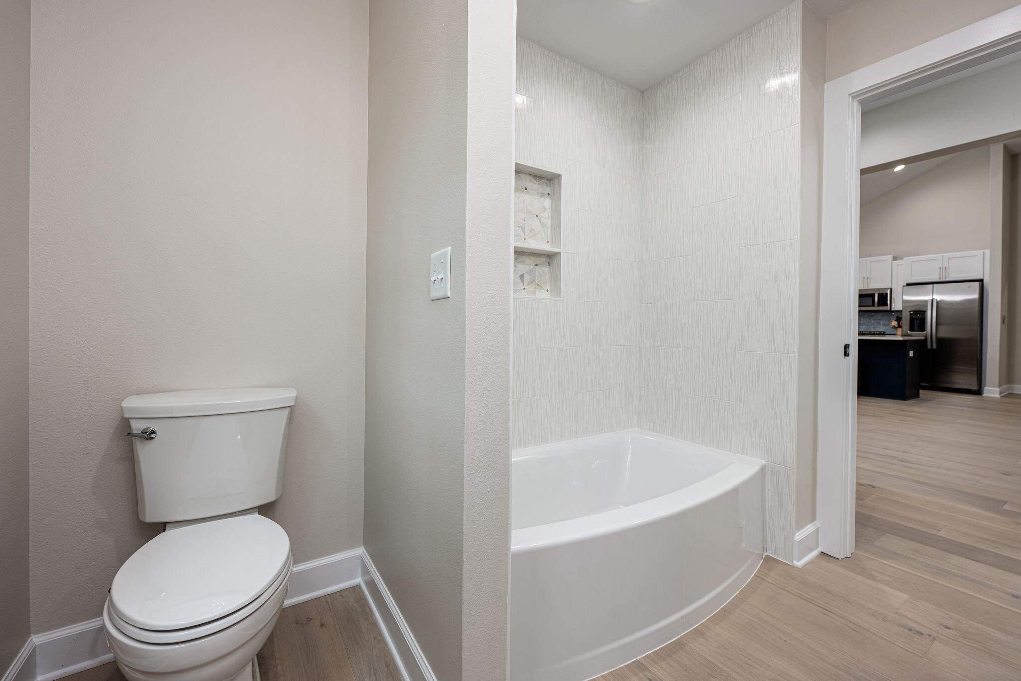 89 Spring Hill Road DeFuniak Springs, FL 32433 - Photo 30 of 73 a white toilet sitting next to a bathroom sink and tub