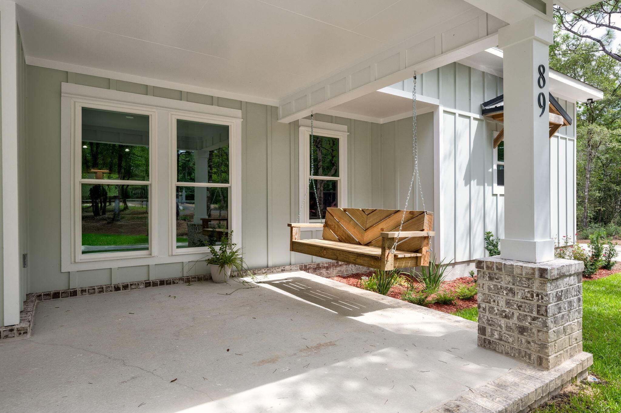 89 Spring Hill Road DeFuniak Springs, FL 32433 - Photo 3 of 73 a backyard of a house with sofas table and chairs