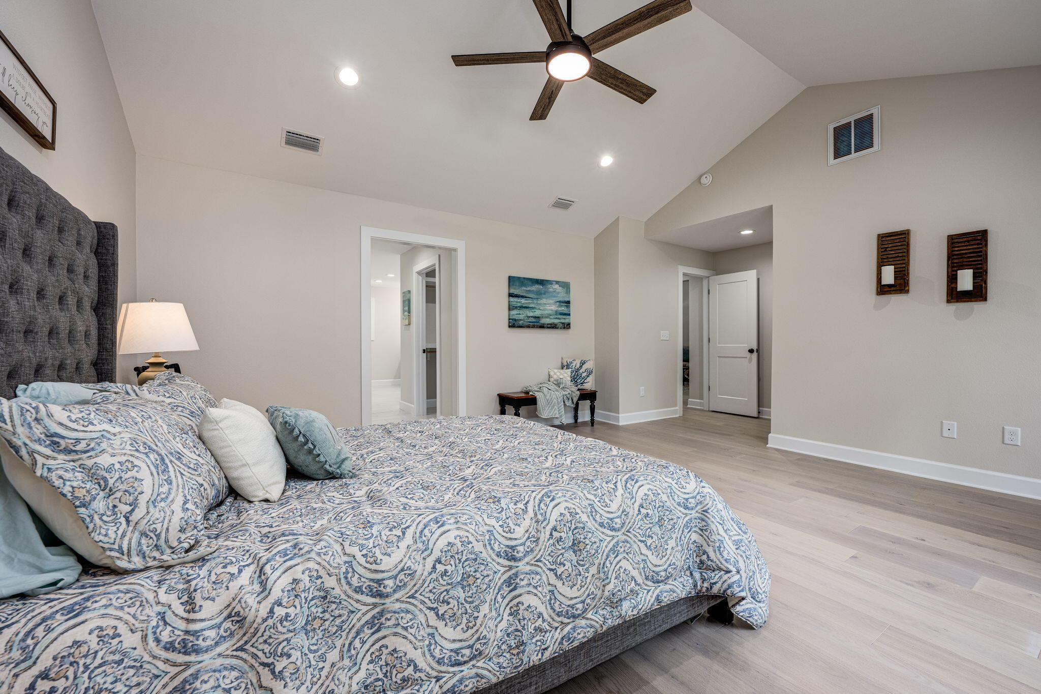 89 Spring Hill Road DeFuniak Springs, FL 32433 - Photo 38 of 73 a bedroom with a large bed and a chandelier