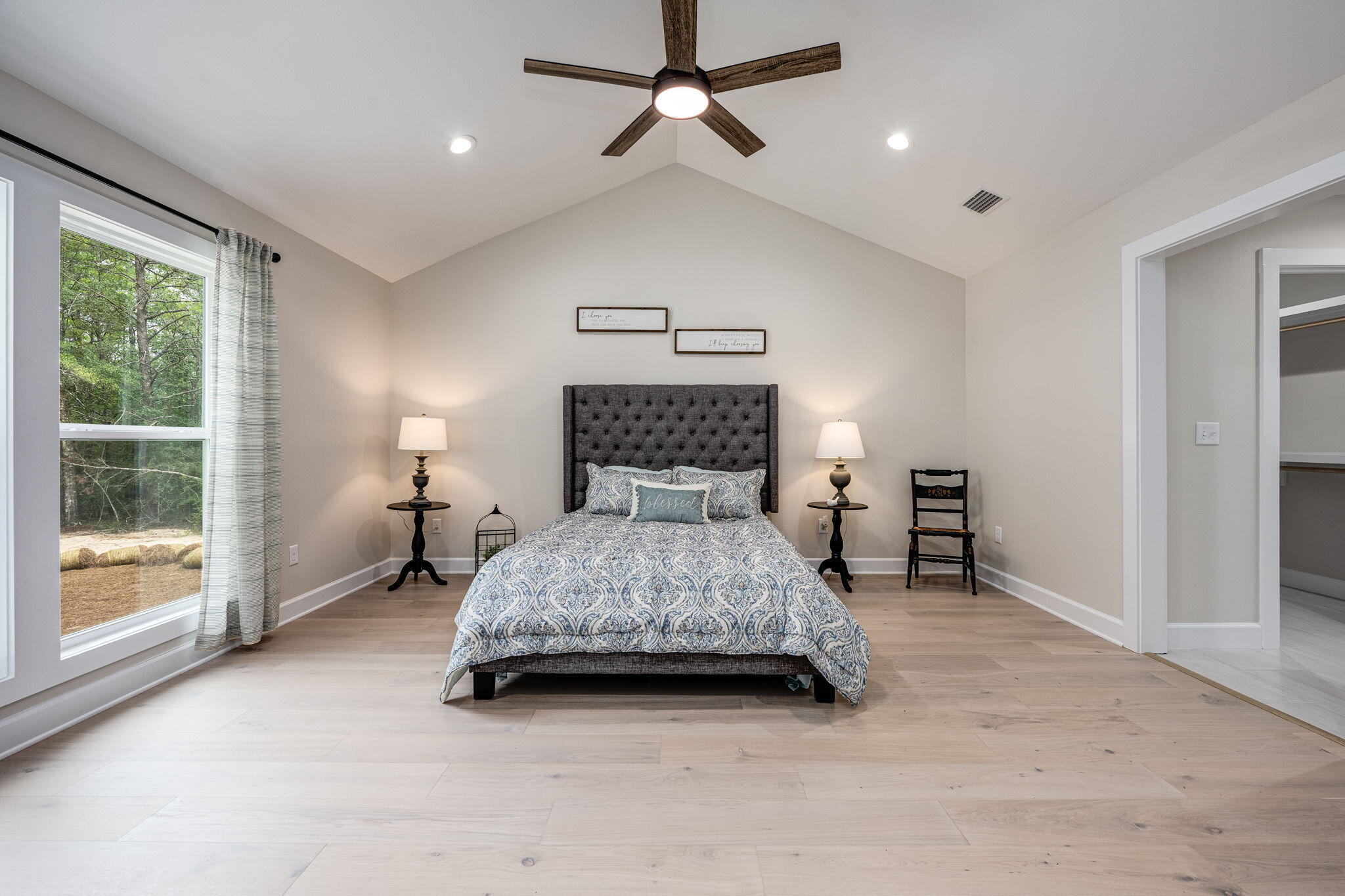 89 Spring Hill Road DeFuniak Springs, FL 32433 - Photo 53 of 73 a spacious bedroom with a bed and a lamp