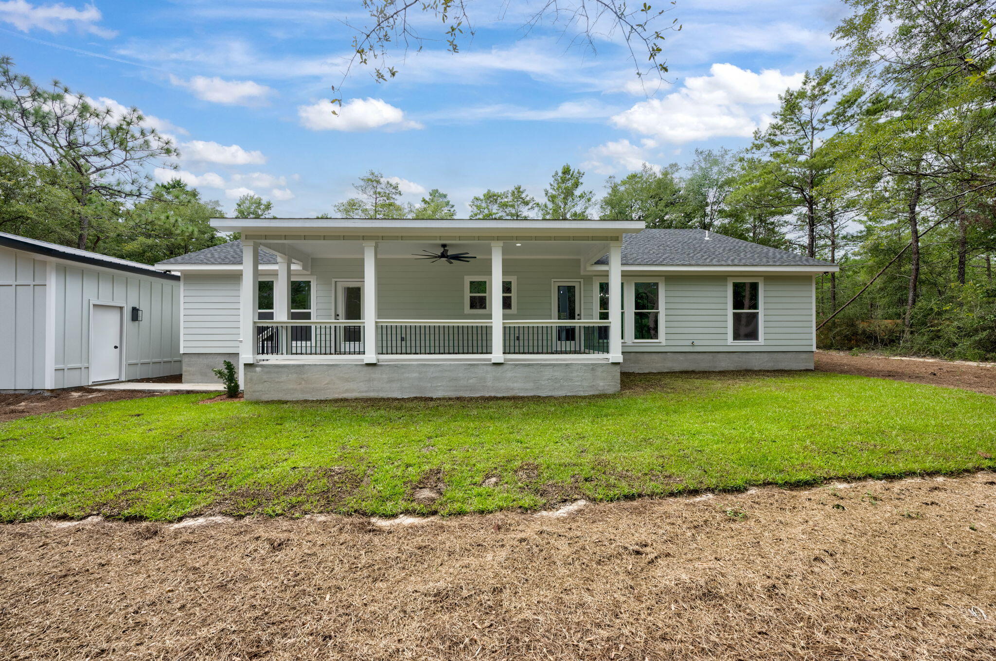 89 Spring Hill Road DeFuniak Springs, FL 32433 - Photo 66 of 73 a front view of a house with a garden