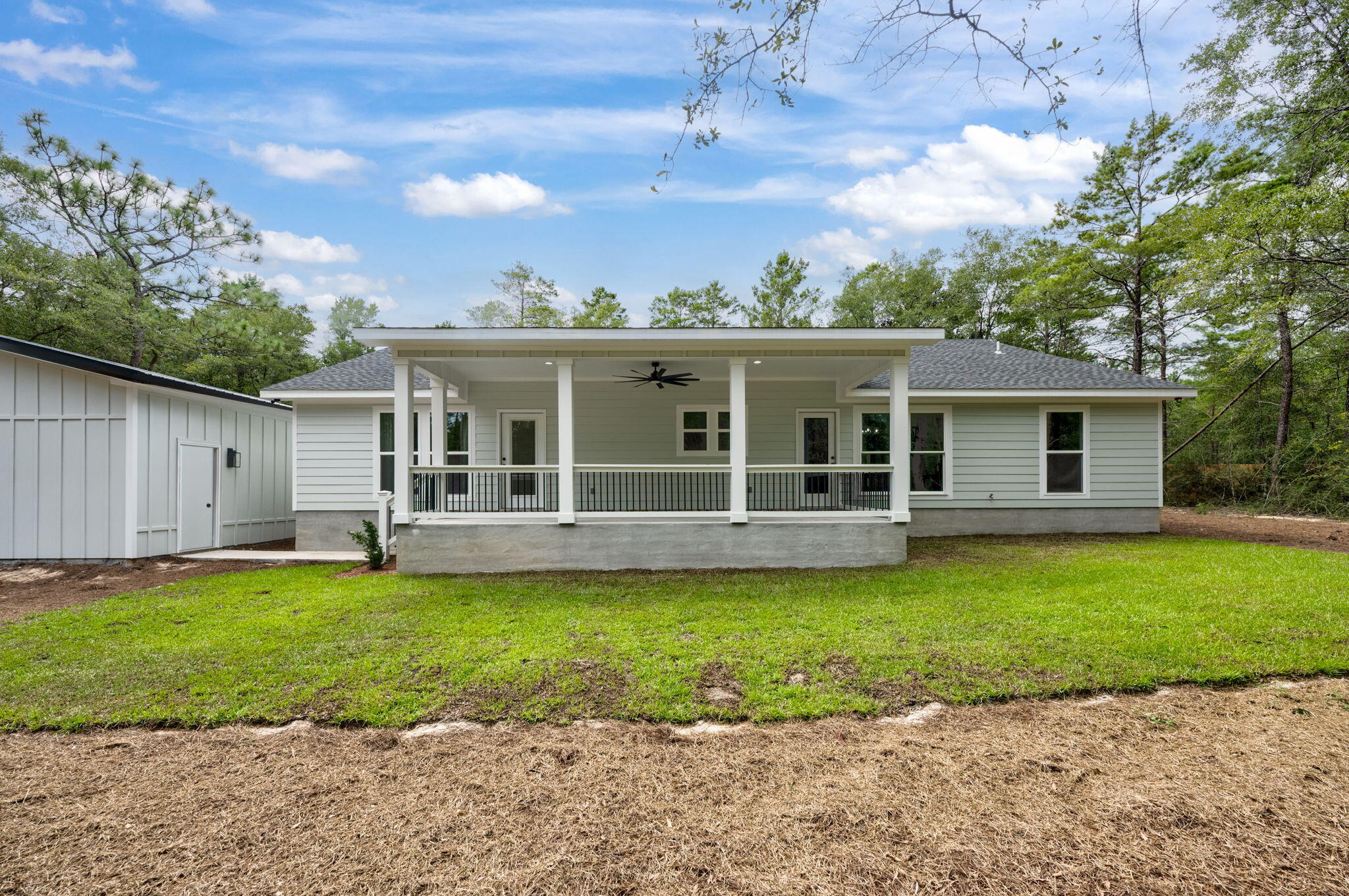 89 Spring Hill Road DeFuniak Springs, FL 32433 - Photo 67 of 73 a view of a house with a swimming pool and a yard