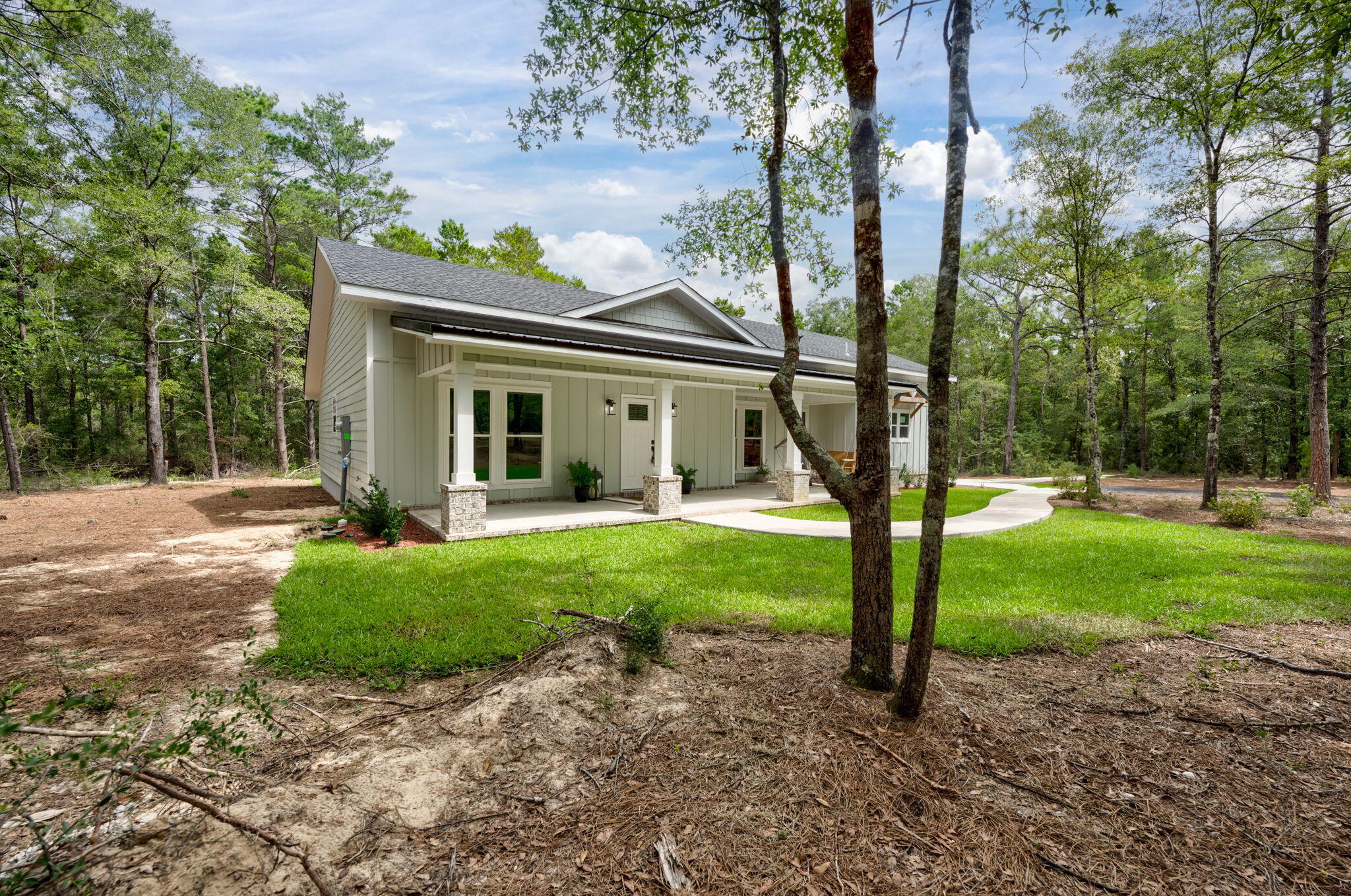89 Spring Hill Road DeFuniak Springs, FL 32433 - Photo 69 of 73 a view of a house with backyard and a tree