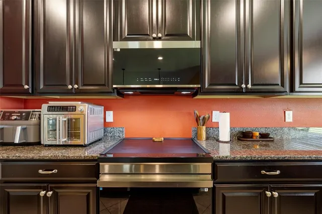 a kitchen with a stove and cabinets