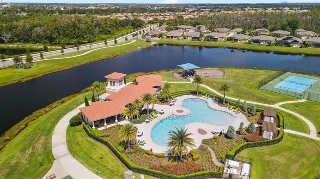 an aerial view of a swimming pool with a lake view