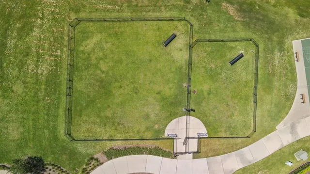 a house that is sitting in the grass with large trees