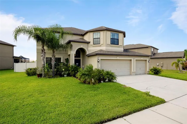 a front view of a house with a yard and garage