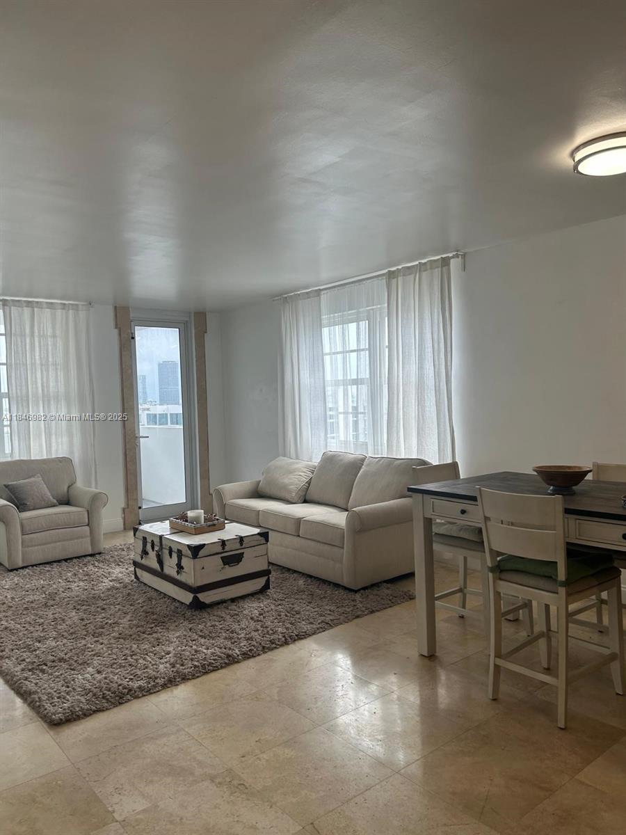 Miami Beach City Center Miami Beach, FL 33139 - Photo 1 of 41 a living room with furniture a rug and a large window