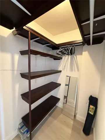 a bathroom with a toilet a sink and view of a mirror