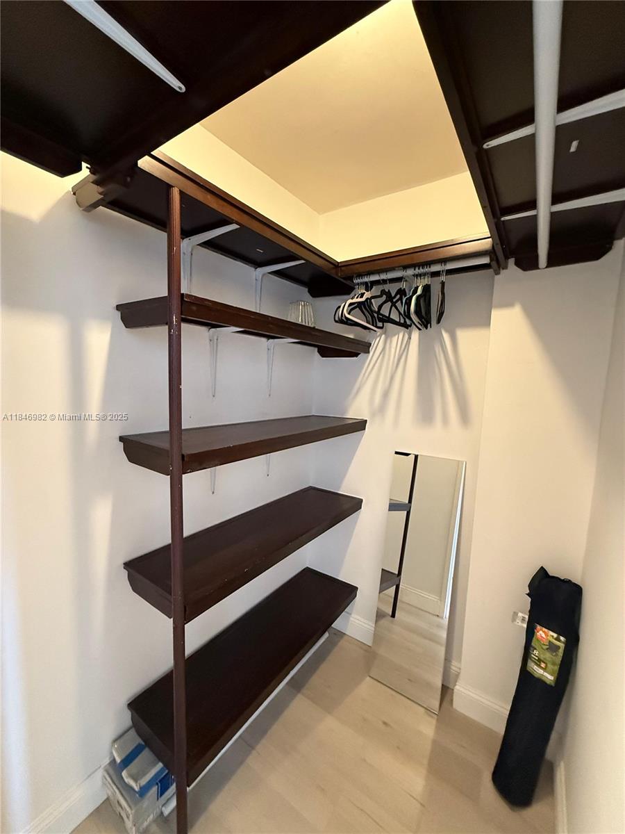 Miami Beach City Center Miami Beach, FL 33139 - Photo 16 of 41 a view of walk in closet with clothes and shoes