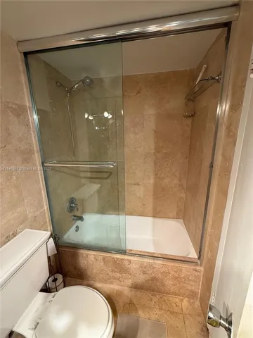 a bathroom with a double vanity sink mirror and toilet