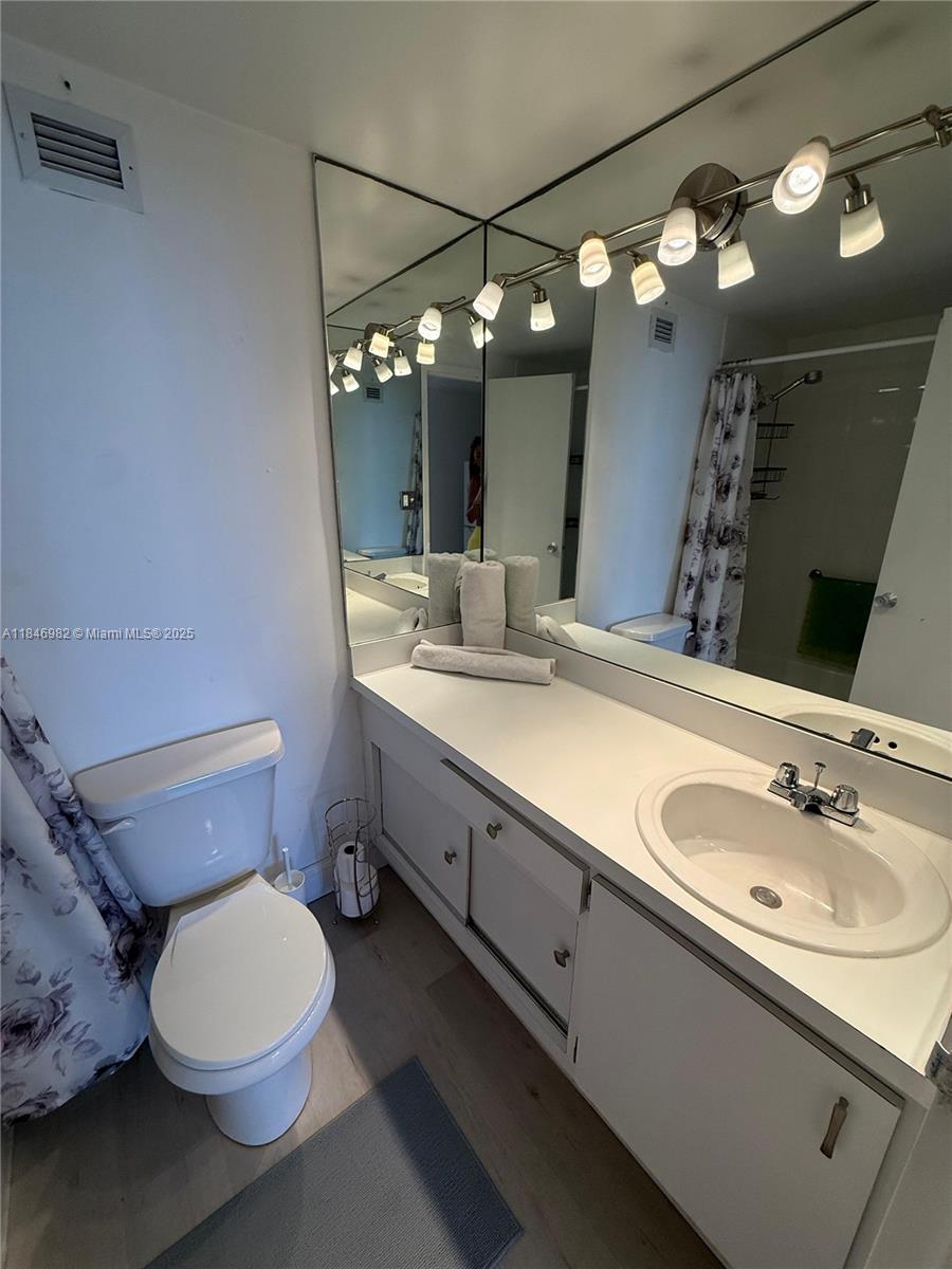 Miami Beach City Center Miami Beach, FL 33139 - Photo 20 of 41 a bathroom with a double vanity sink mirror and toilet