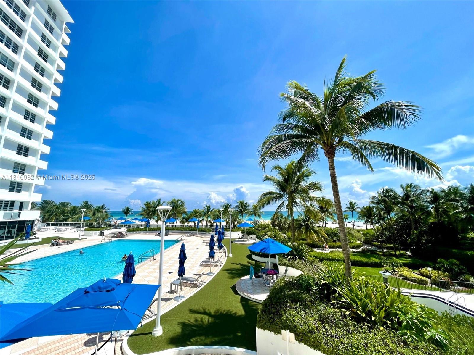 Miami Beach City Center Miami Beach, FL 33139 - Photo 24 of 41 a group of people sitting in a yard with swimming pool
