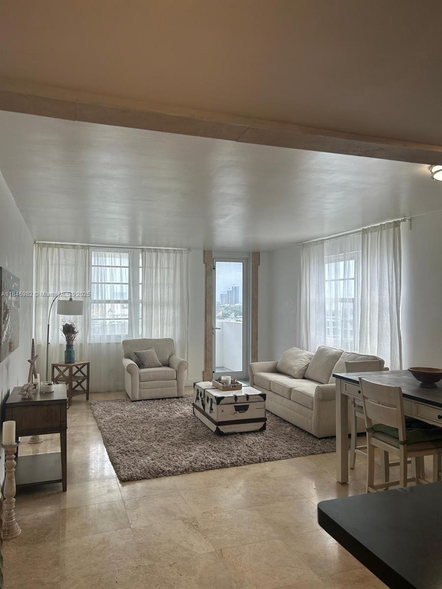 Miami Beach City Center Miami Beach, FL 33139 - Photo 3 of 41 a living room with furniture wooden floor and a large window