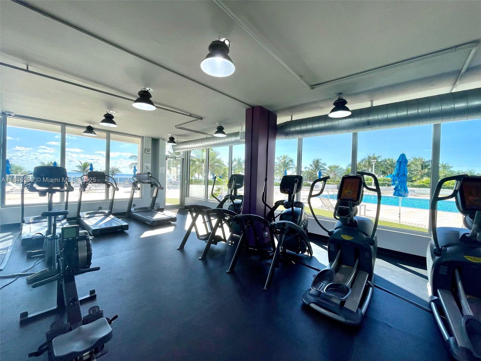 Miami Beach City Center Miami Beach, FL 33139 - Photo 31 of 41 a room with gym equipment and large window