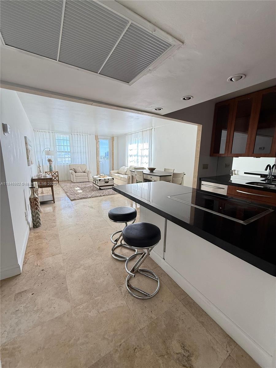 Miami Beach City Center Miami Beach, FL 33139 - Photo 38 of 41 a kitchen with counter top space cabinets and stainless steel appliances