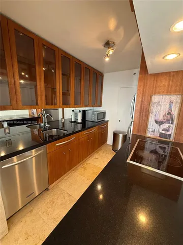 a kitchen with stainless steel appliances a sink a stove and a refrigerator
