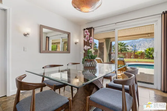 a dining room with furniture and a window