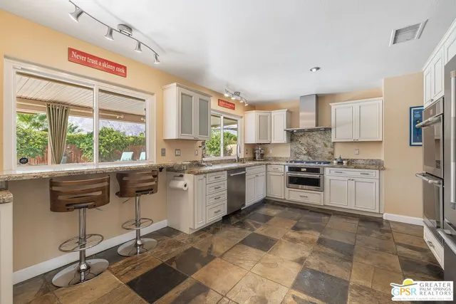 a kitchen with a stove a sink and a refrigerator