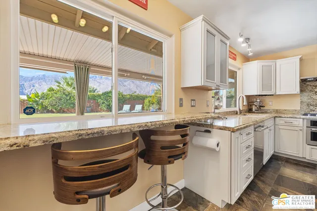 a kitchen with a stove a sink and cabinets