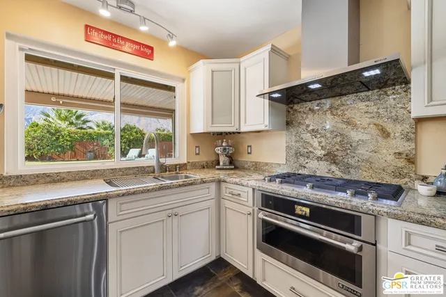 a kitchen with stainless steel appliances white cabinets and a sink