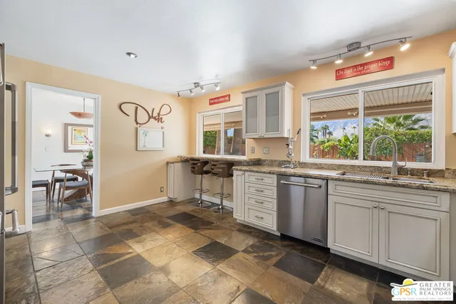 a kitchen with a sink window and cabinets
