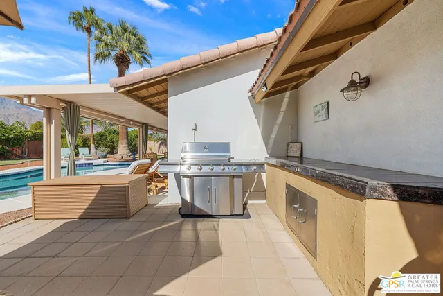 a kitchen with stainless steel appliances granite countertop a sink and stove