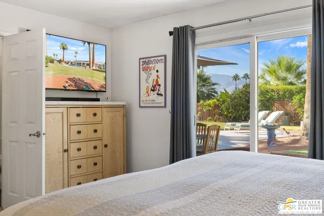 a large bedroom with a bed and a window