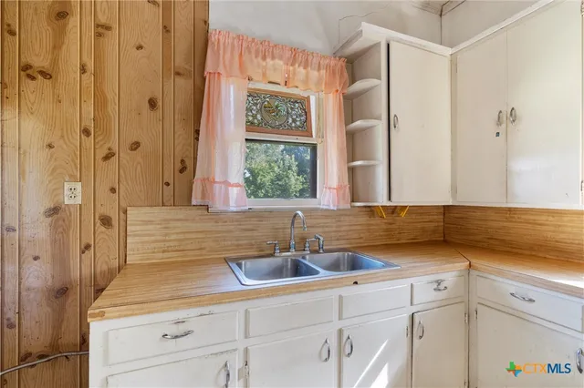 a kitchen with a sink and cabinets