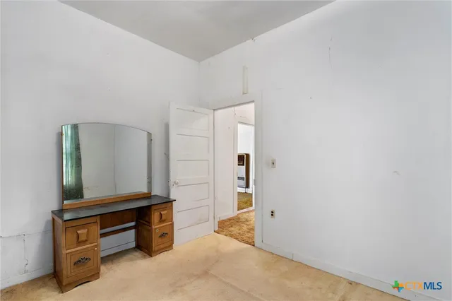 a view of a kitchen with a refrigerator and a sink