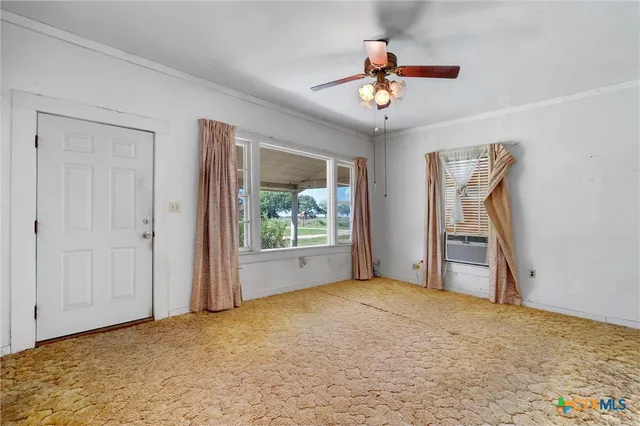 a view of room with window and ceiling fan