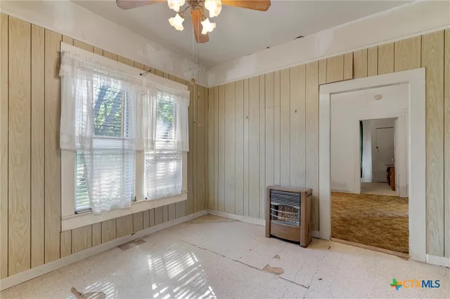 a view of a bedroom with cabinet mirror and windows