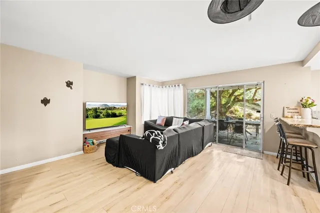 a living room with furniture a window and a flat screen tv