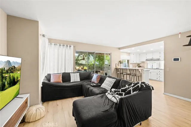 a living room with furniture and a floor to ceiling window