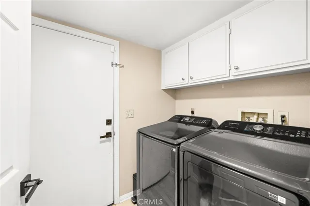 a utility room with sink dryer and washer