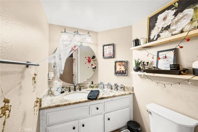 a bathroom with a granite countertop sink vanity mirror and shower