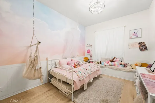 a kitchen with a sink dishwasher a stove and a refrigerator with wooden floor