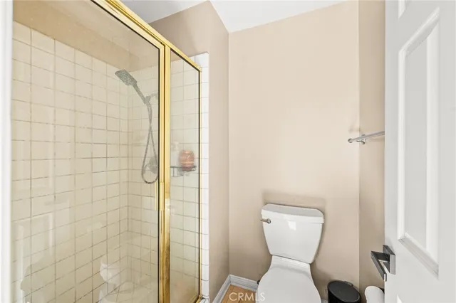 a backyard of a house with a fountain plants and large tree